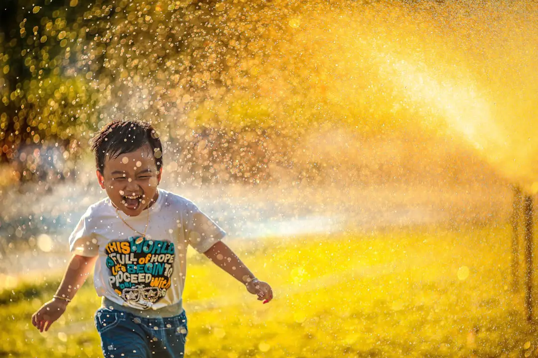 Conclusion by Teacher Supply Store a young boy running through a sprinkle of water