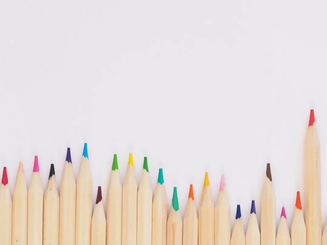 colored pencil lined up on top of white surface