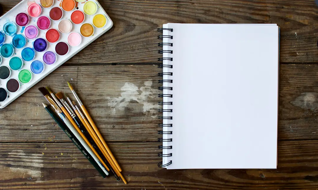 When inspiration strikes by Teacher Supply Store paint brushes next to drawing book and water color palette