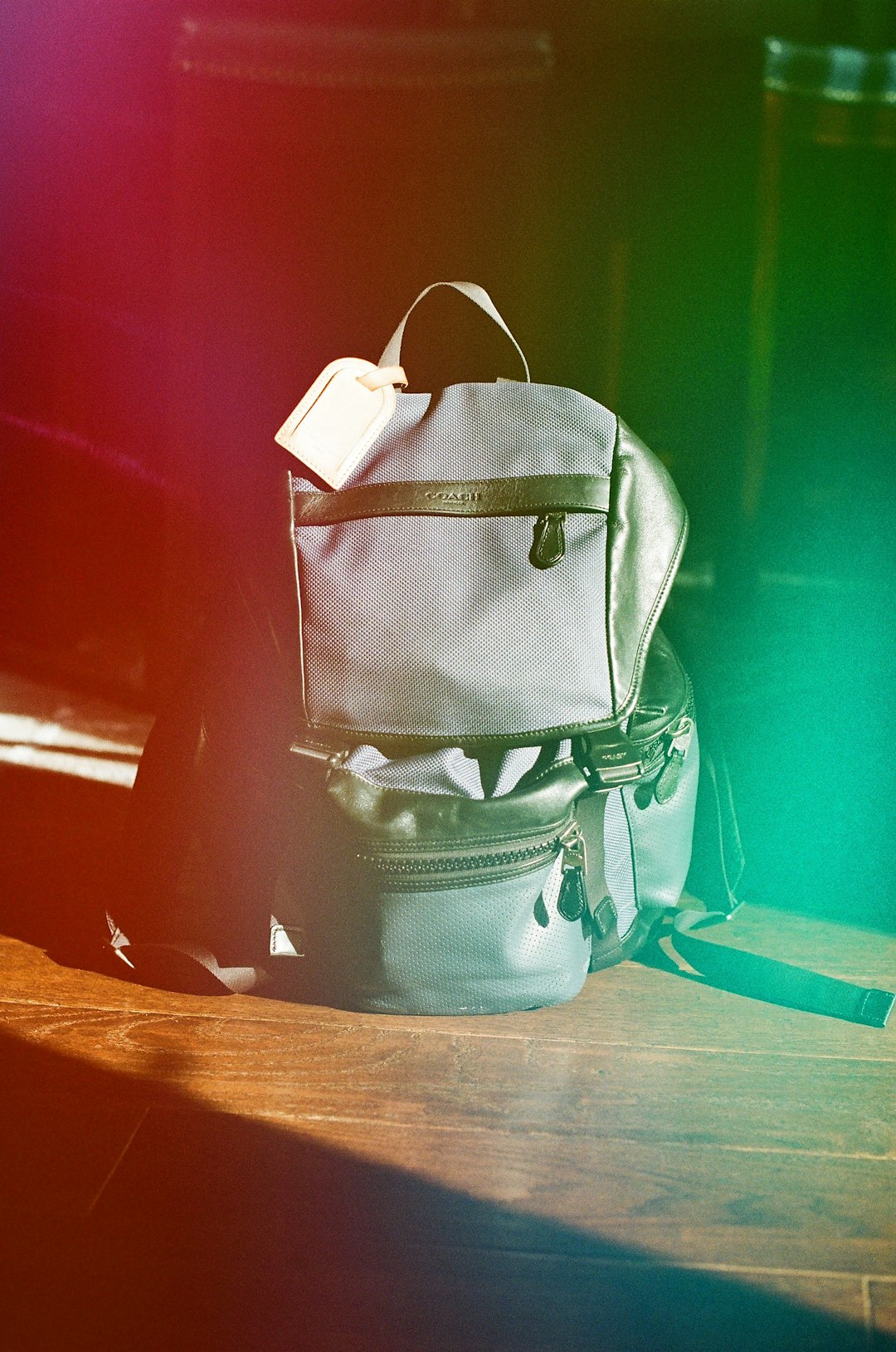 blue and white backpack on brown wooden table