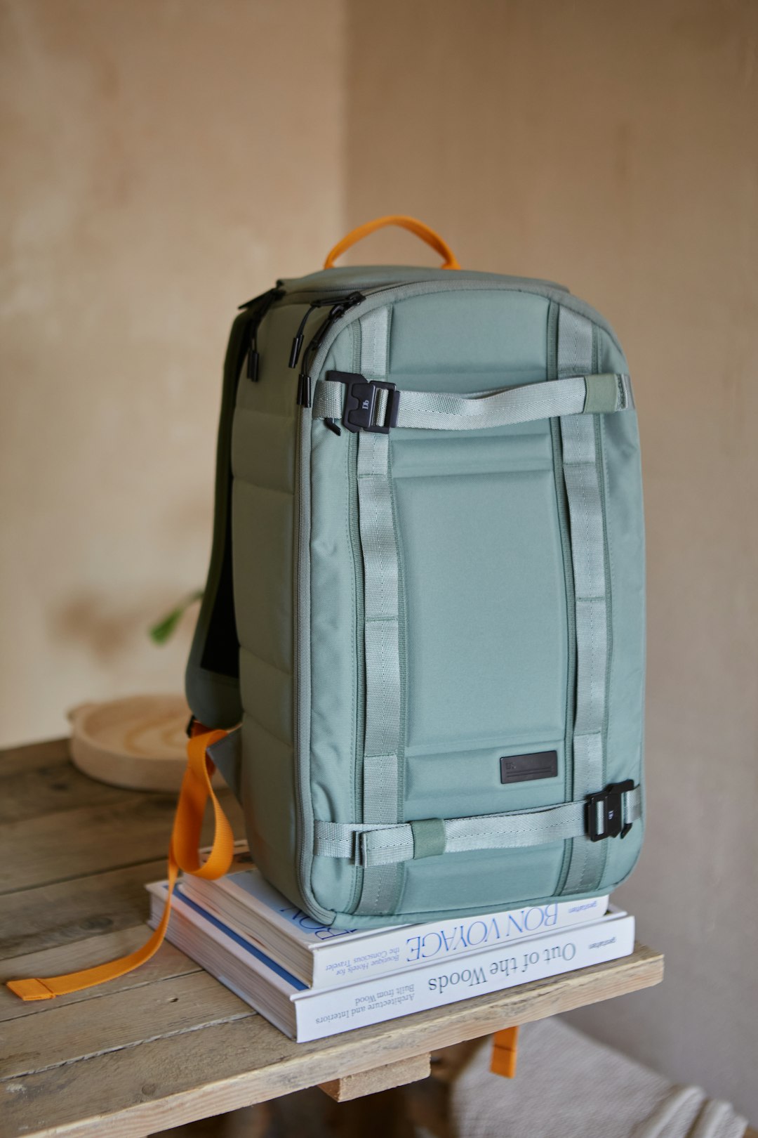 A backpack sitting on top of a stack of books